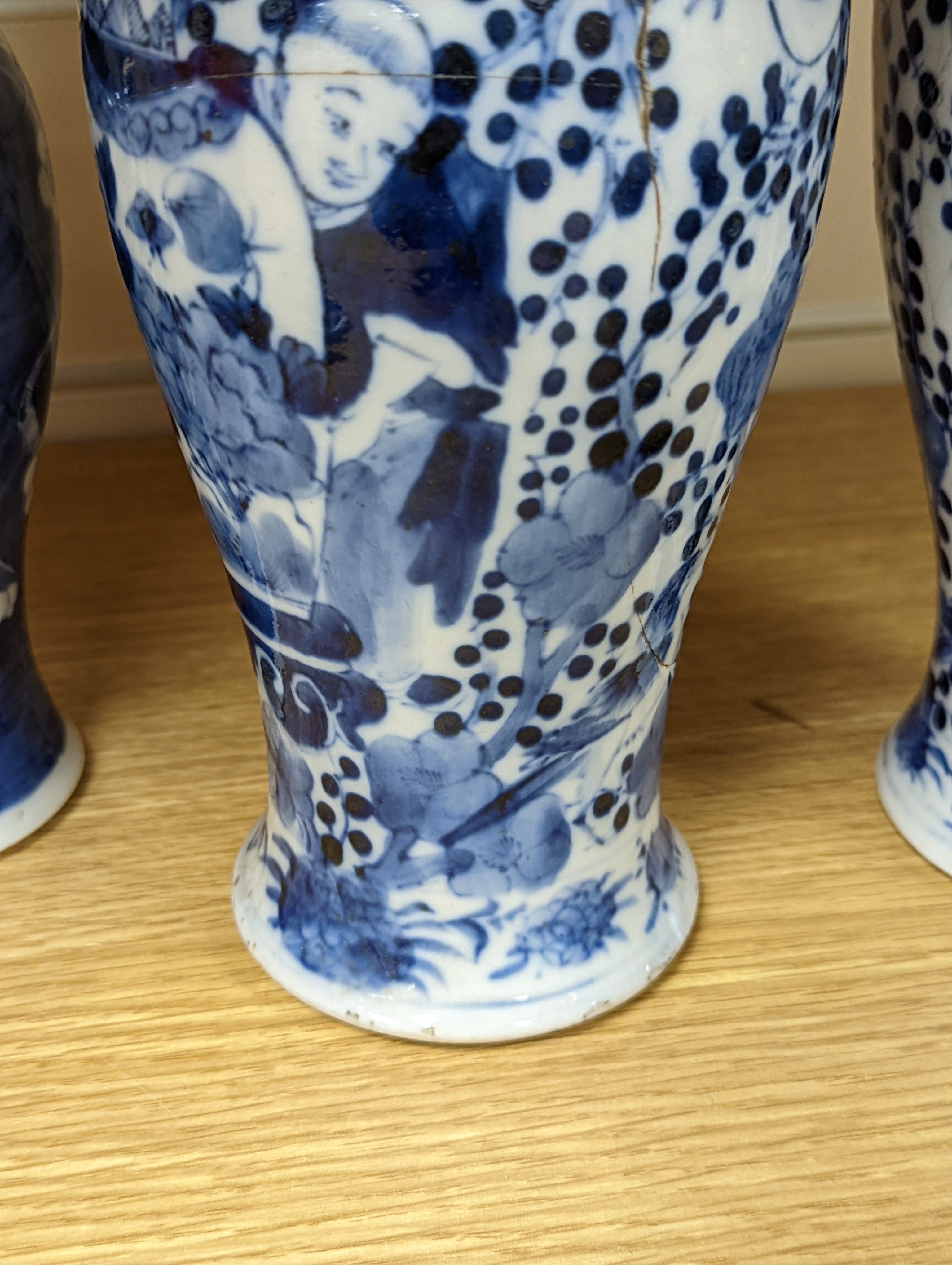 A pair of 19th century Chinese blue and white vases, a prunus vase and cover and a similar jar (4), pair of vases 24 cms high.